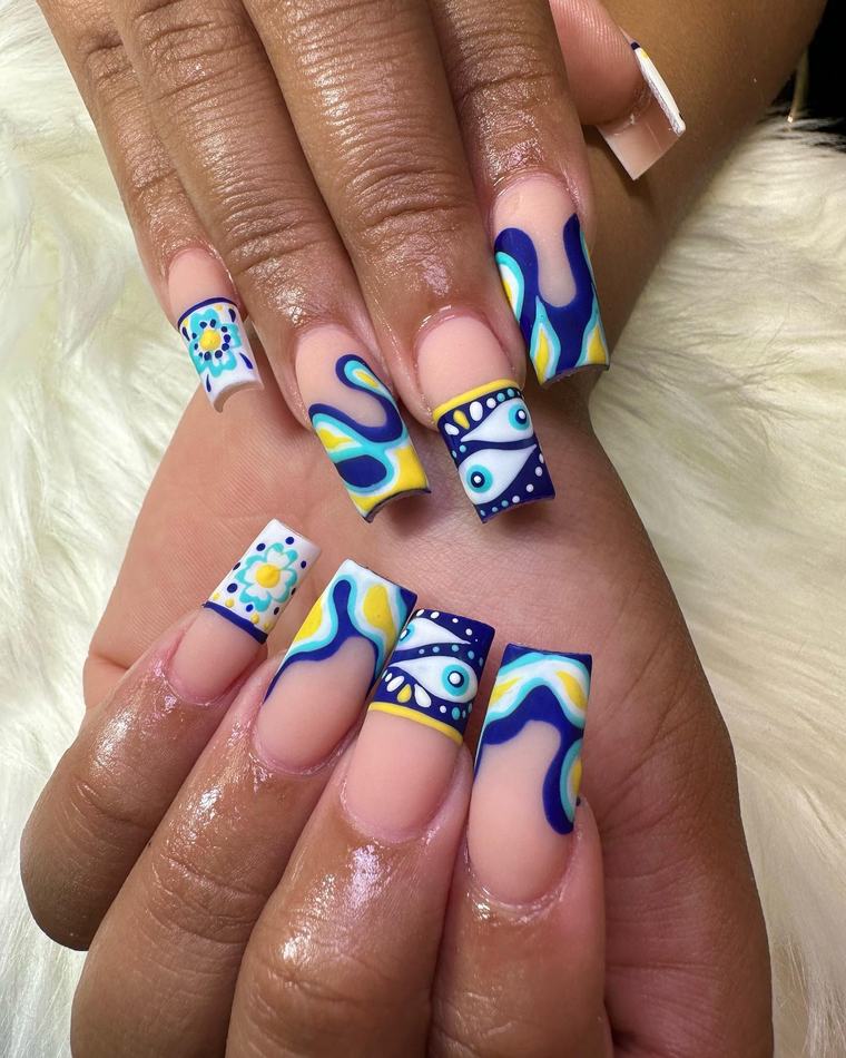 Long square nails with colorful evil-eye, flower and swirl nail art in blue, yellow and white