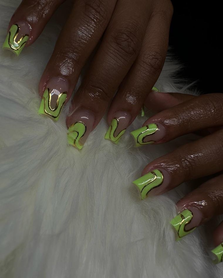Short square nails with lime-green French tips outlined in gold swirls